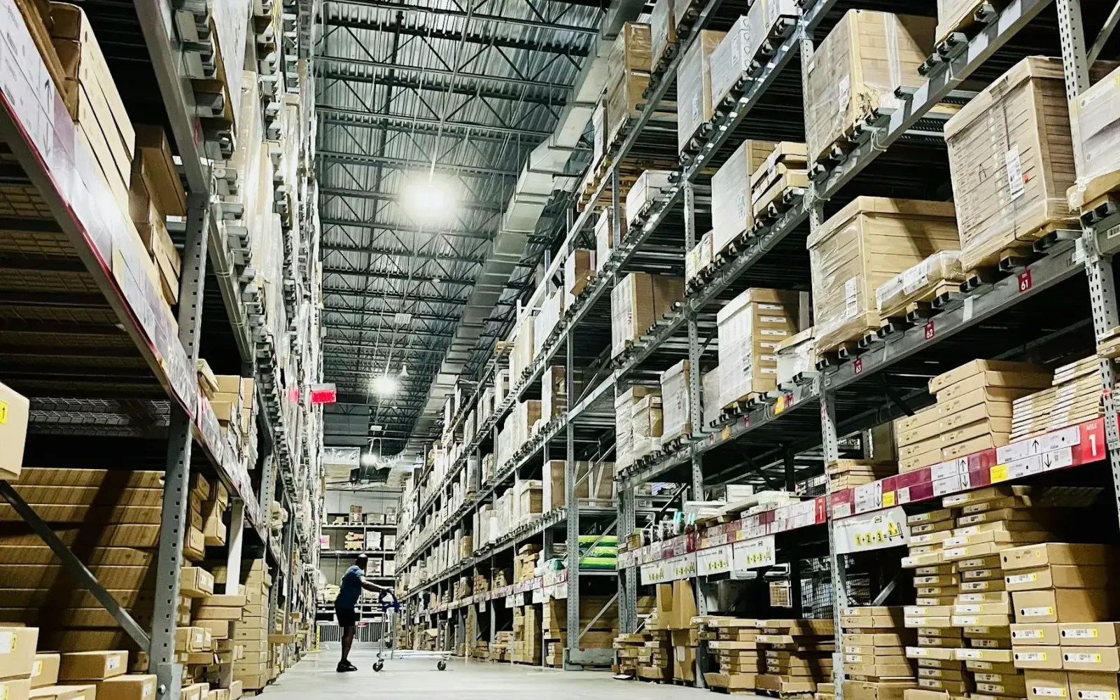 Tall warehouse shelves stacked with cardboard boxes