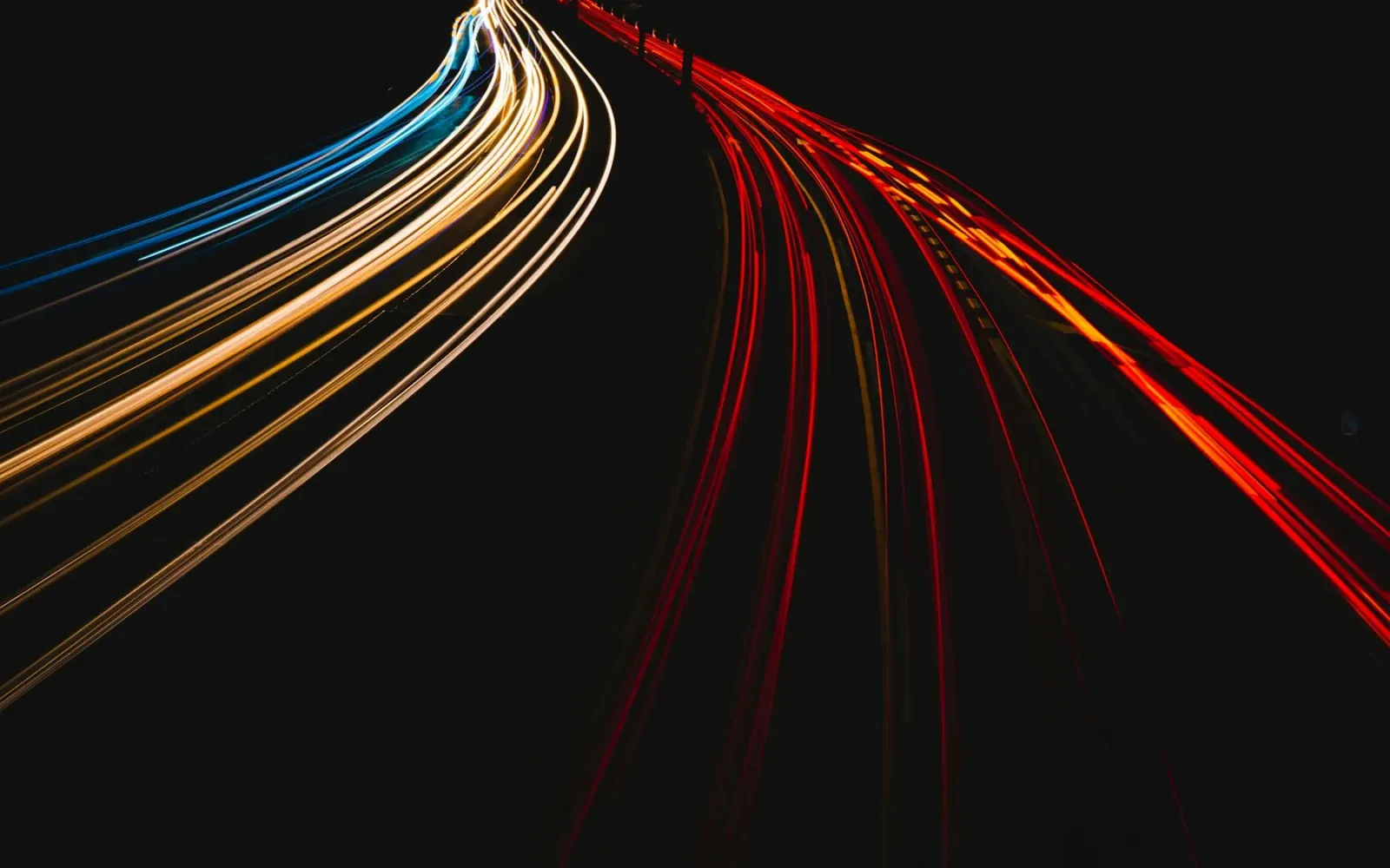 Red and white light trails from fast-moving traffic at night
